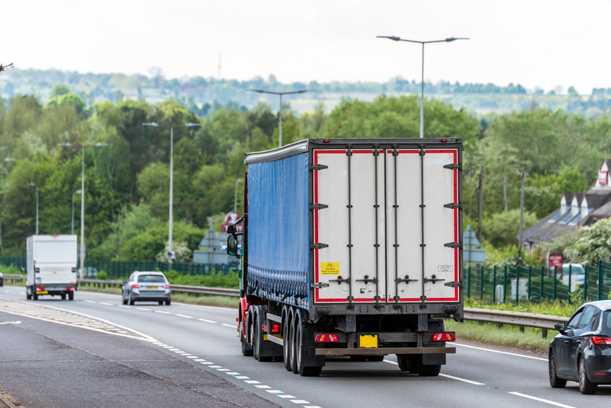 Curtain side lorry truck on uk motorway in fast motion.